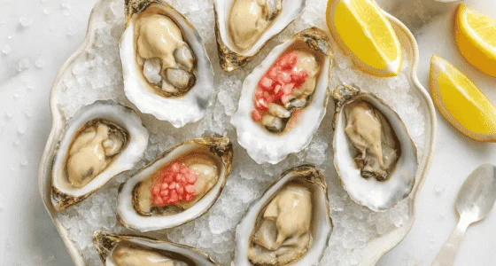 Fresh Oualidia oysters with red wine vinegar on a bed of ice
