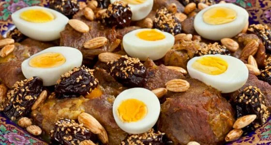 Slow-cooked lamb tagine with caramelized onions and raisins served in a traditional clay pot